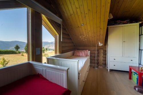 a bedroom with a bed and a large window at The Flysch in Miríki