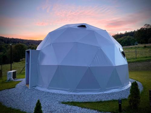 a large white tent sitting in a field at Poziom 713 in Trzebunia