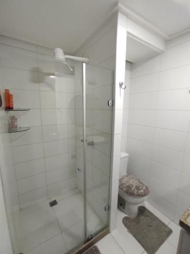 a bathroom with a glass shower with a toilet at Flat Manaíra Palace in João Pessoa