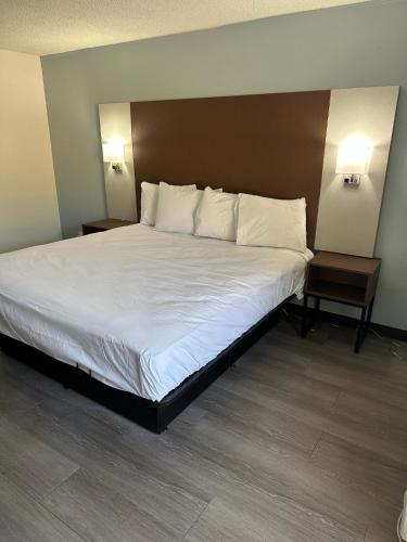1 cama grande en una habitación de hotel con 2 mesas en My Home at Columbus, en Columbus