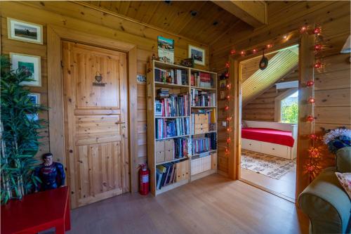 a room with a book shelf and a bedroom at The Flysch in Miríki