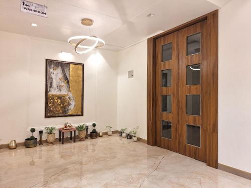 a hallway with a wooden door and a painting at The Utopia Resort Sanchi in Sānchi