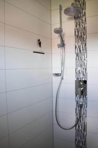 a shower with a shower head in a bathroom at Ferienwohnung Wolf in Veringenstadt