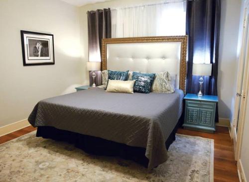 a bedroom with a large bed with pillows on it at The Elvis House in Waco