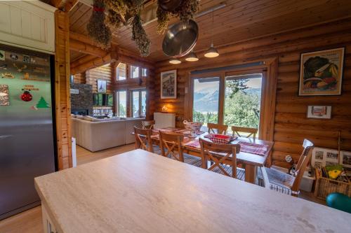 a kitchen and dining room of a log cabin at The Flysch in Miríki