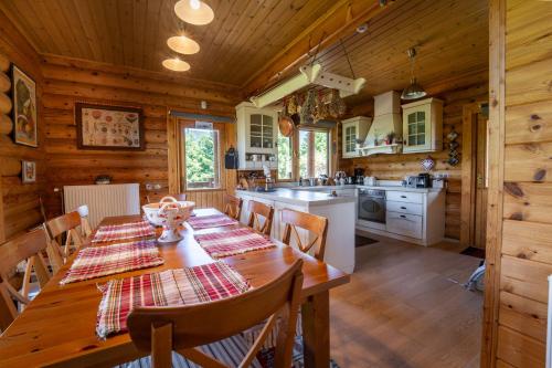 a kitchen and dining room with a long wooden table at The Flysch in Miríki