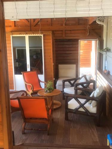a patio with chairs and a table on a deck at Villa HAVRE DE PAIX in Le Gosier