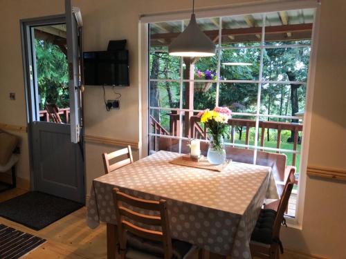 a dining room table with a vase of flowers on it at Willow Lodge in Dublin