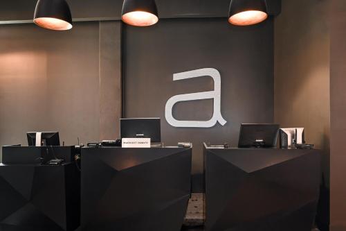 a lobby with two desks with laptops on them at Aloft Charlotte City Center in Charlotte