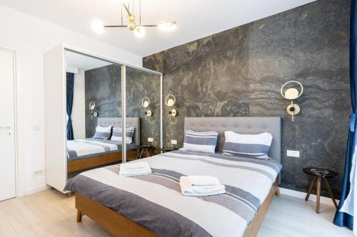 a bedroom with two beds and a wall mural at Blue Velvet in Bucharest