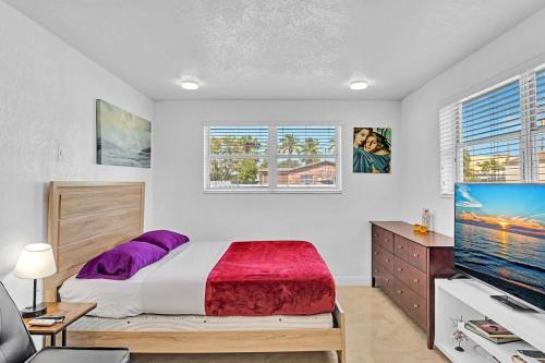 a bedroom with a bed and a flat screen tv at Hollywood Vacation Mins To Beach & Hard Rock #193 in Hollywood