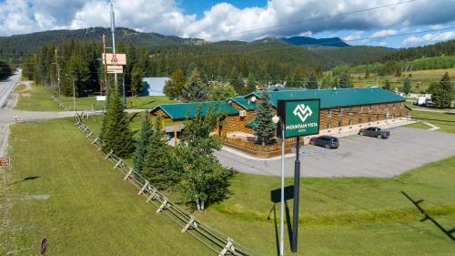a large building with a sign in front of it at Mountain Vista Hotel in West Yellowstone