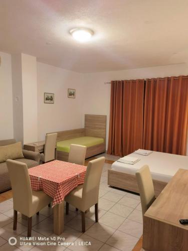 a room with a bed and a table and chairs at Lovely Bosnian Home in Mostar