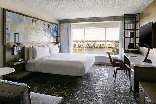 a hotel room with a bed and a large window at Marriott Dallas Las Colinas in Irving