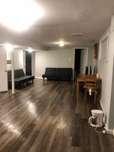 an empty living room with a couch and a table at Alexandria Spacious 1Bedroom in Alexandria