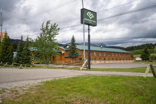 a sign in front of a wooden building at Mountain Vista Hotel in West Yellowstone