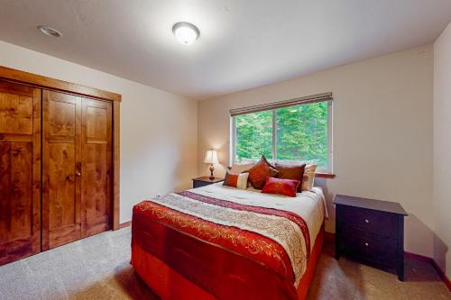 a bedroom with a large bed and a window at Bigfork Beauty in Bigfork
