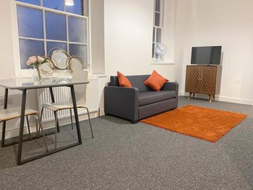 a living room with a couch and a table at Bridgewater apartment in Bridgwater