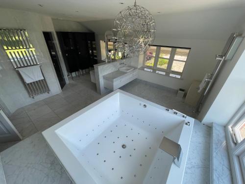 an overhead view of a bathroom with a large tub at Fernside house and barns in Pickmere