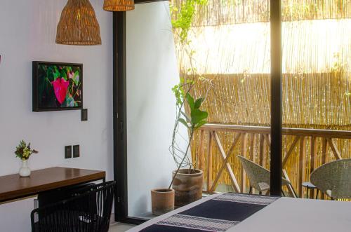 a dining room with a table and a window at Ximena Hotel Boutique in Sayulita