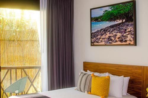 a bedroom with a bed with a view of a beach at Ximena Hotel Boutique in Sayulita