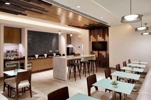 a kitchen and dining room with tables and a chalkboard at Marriott Cincinnati Airport in Hebron