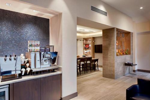 a living room with a kitchen and a dining room at Marriott Cincinnati Airport in Hebron