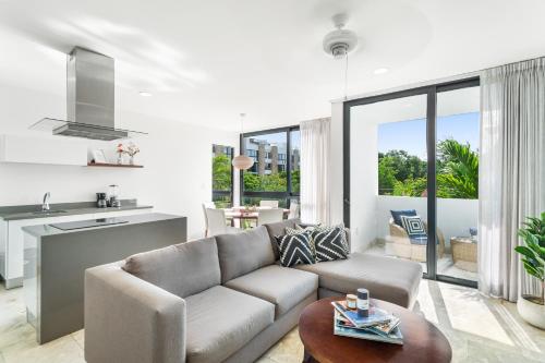 a living room with a couch and a table at Downtown Condos Luxury in Playa del Carmen