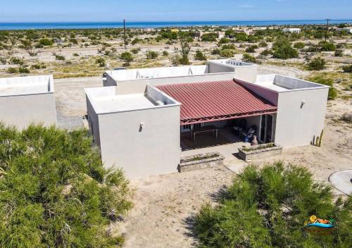 an aerial view of a white building with a red roof at Casa Desert Rose in Playa Hawaii