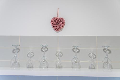 a shelf with wine glasses and a heart on the wall at Flexible SelfCheckIns 56 - Zagreb - Garage - Loggia - New in Zagreb