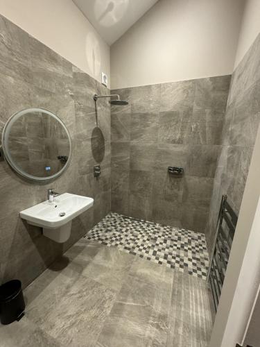 a bathroom with a sink and a mirror at 3 Millstones Inn in West Bradford