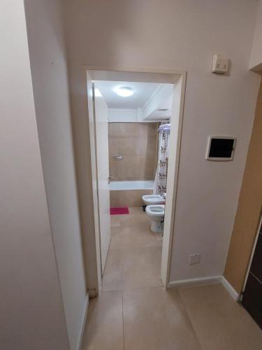 a hallway with a bathroom with two toilets in a room at departamentos lasserre in Río Grande