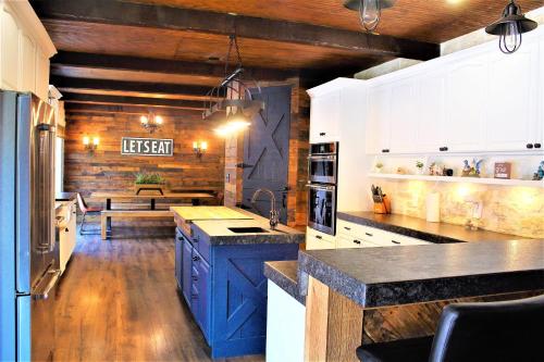 a kitchen with blue cabinets and a bench in the background at The Rustic Inn - Family friendly, Close to Fiesta Texas, SeaWorld, Riverwalk and more in Dominion