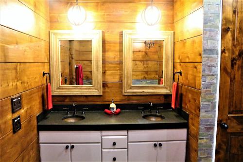a bathroom with two sinks and two mirrors at The Rustic Inn - Family friendly, Close to Fiesta Texas, SeaWorld, Riverwalk and more in Dominion