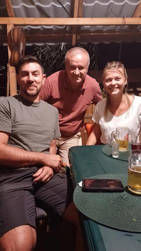 a group of three people sitting at a table at Casa Mocanu in Giurgiu
