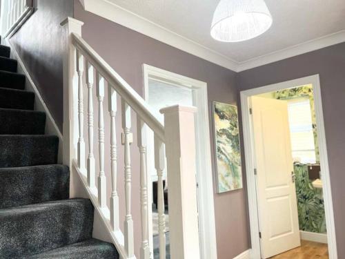 a staircase in a home with a white door at 4Bed Home MK in Shenley Brook End