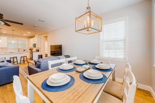 a dining room and living room with a table and chairs at Cozy Coastal Cottage in Port Saint Joe