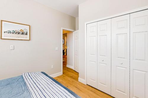 a bedroom with white walls and a large white closet at Cozy Coastal Cottage in Port Saint Joe