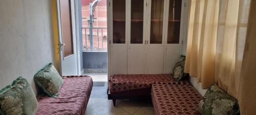 a room with two couches and a window at appartement adam in Oujda