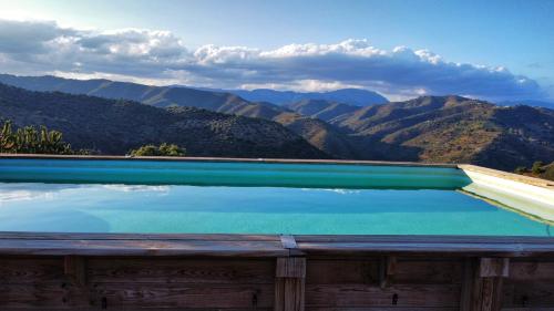 a swimming pool with a view of mountains at Finca Serrato in Colmenar