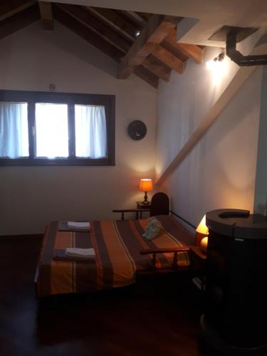 a bedroom with a bed and a window at Grande appartamento I Faggi in Abetone