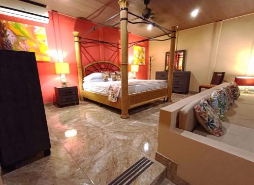 a bedroom with a canopy bed in a room at Suite Paraiso Azul in Tamarindo