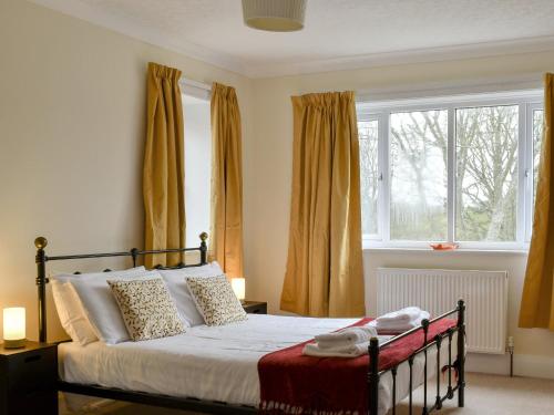 a bedroom with a bed in front of a window at Ryndle Corner in Scarborough