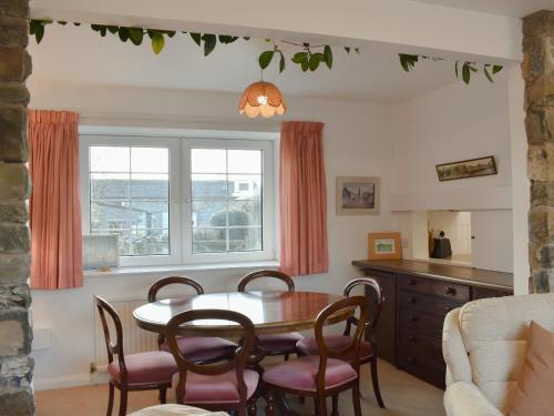 a dining room with a table and chairs and a window at The Bothy in Old Hutton