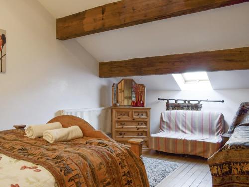 a bedroom with a bed and a chair at High Gate - Uk30579 in Nelson