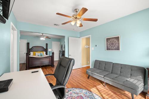 a living room with a couch and a ceiling fan at 1 Min to Beach Ocean Breeze 3BR Pets welcome with pet fee in Galveston