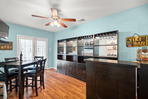 a bar with a table and chairs in a room at 1 Min to Beach Ocean Breeze 3BR Pets welcome with pet fee in Galveston