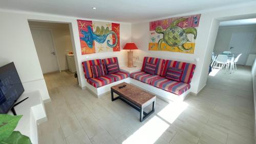 a living room with two couches and a table at Studio with Private Swimming Pool and Garden in Cascais