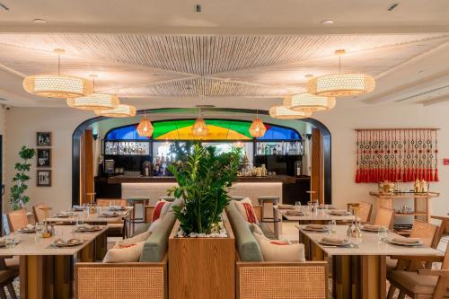 a restaurant with tables and chairs and a bar at Dead Sea Marriott Resort & Spa in Sowayma