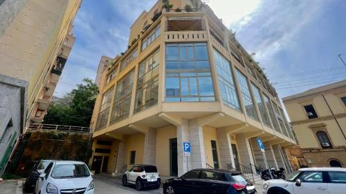 a building with cars parked in front of it at Golden House - Trilocale nel Cuore di Agrigento in Agrigento